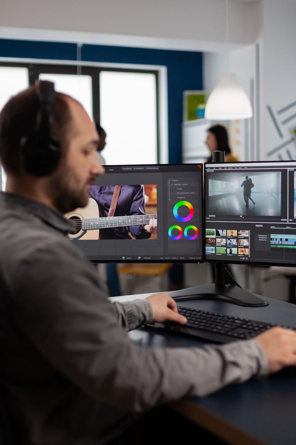 graphic-video-production-working-pc-with-two-displays-editing-video-audio-footage-sitting-creative-workplace-min