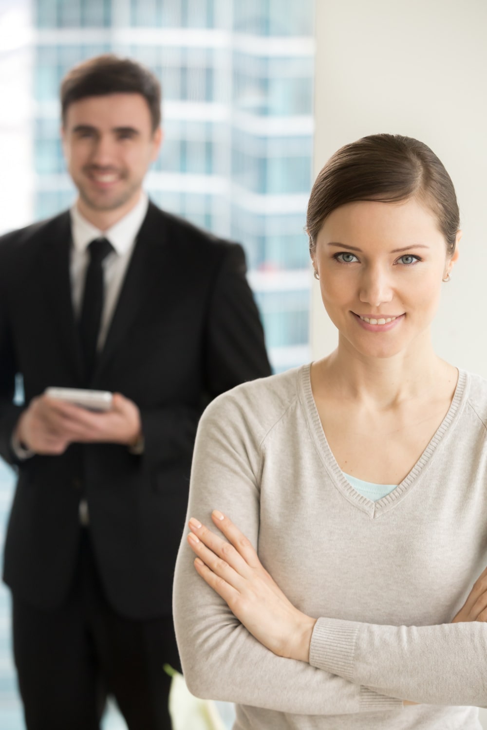 smiling-beautiful-businesswoman-looking-camera-min
