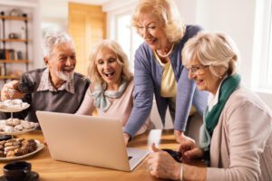 group of happy seniors surfing the net on laptop a 2024 12 13 21 17 10 utc scaled 1