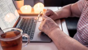retired woman uses laptop hands close up 2025 03 17 04 27 48 utc scaled 1